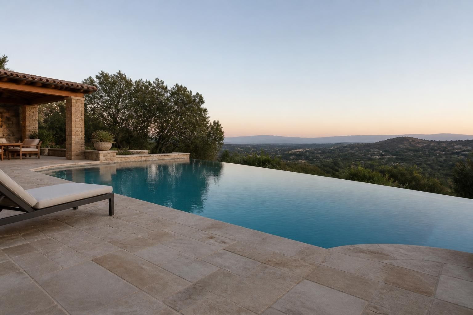 Luxurious infinity pool with natural stone decking and calm water